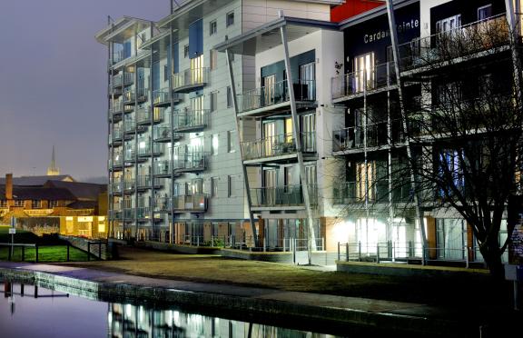 New development of flats overlooking a canal at night time