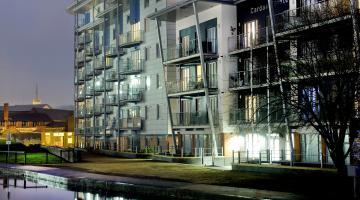 New development of flats overlooking a canal at night time